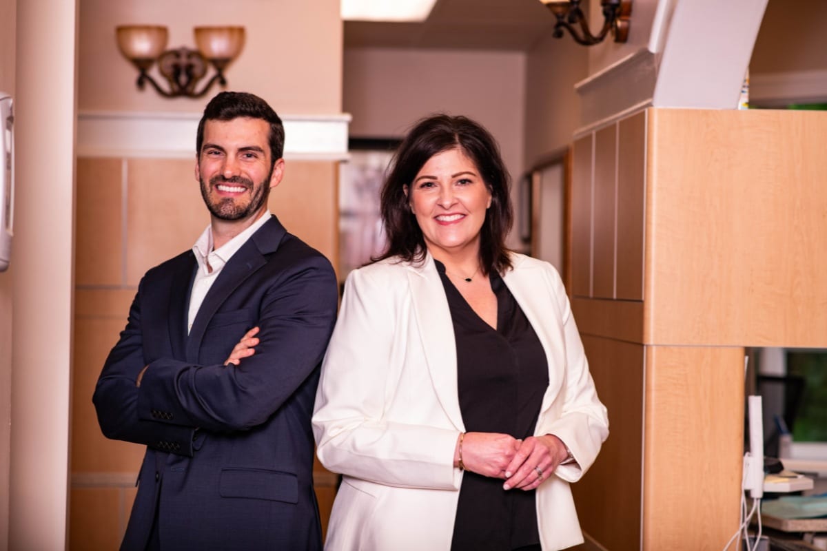 Two dentists standing together and smiling inside The Center for Cosmetic and Restorative Dentistry in Chesapeake, VA.