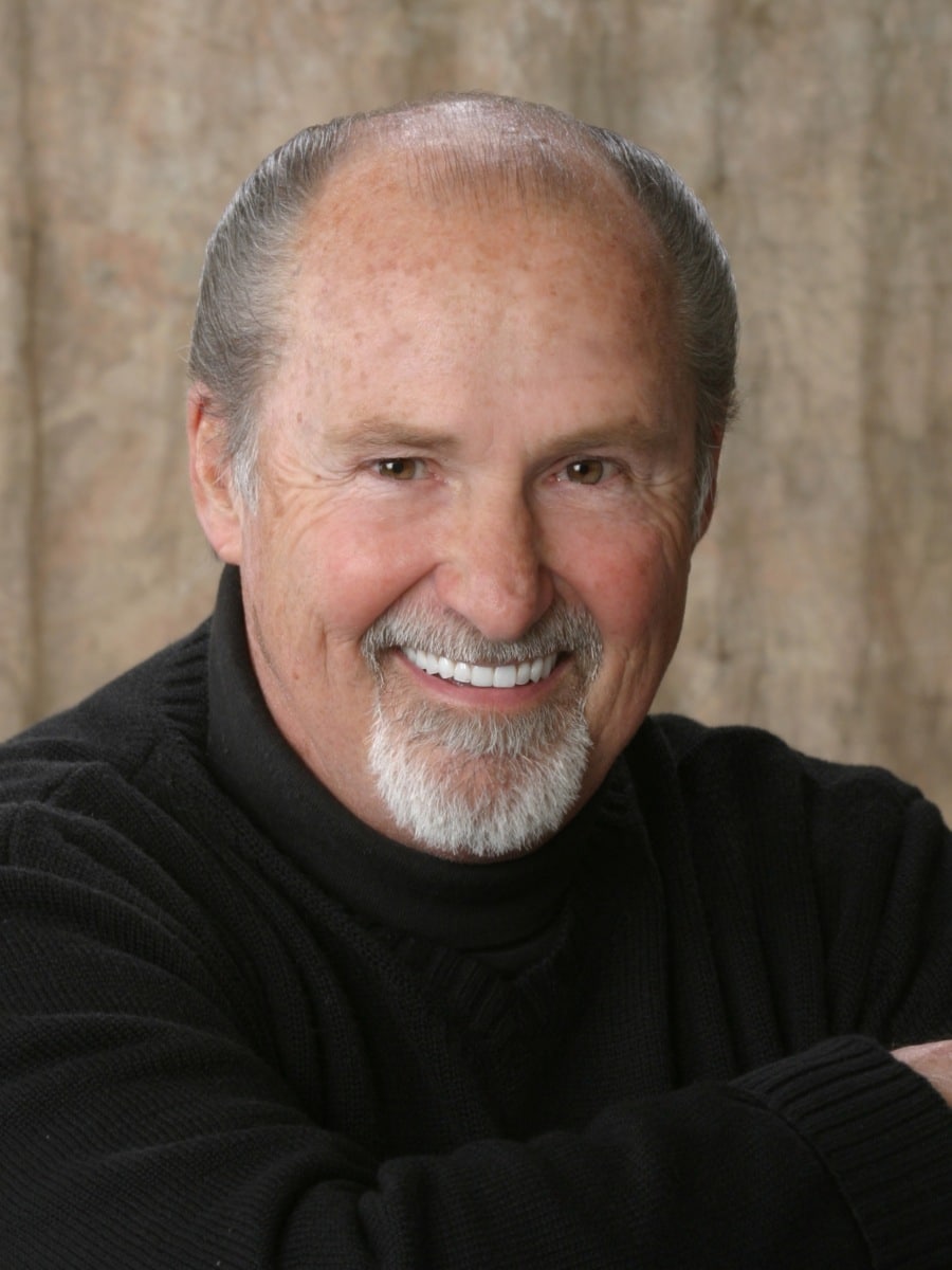 Smiling man showing natural results from custom dentures at The Center for Cosmetic and Restorative Dentistry in Chesapeake, VA.
