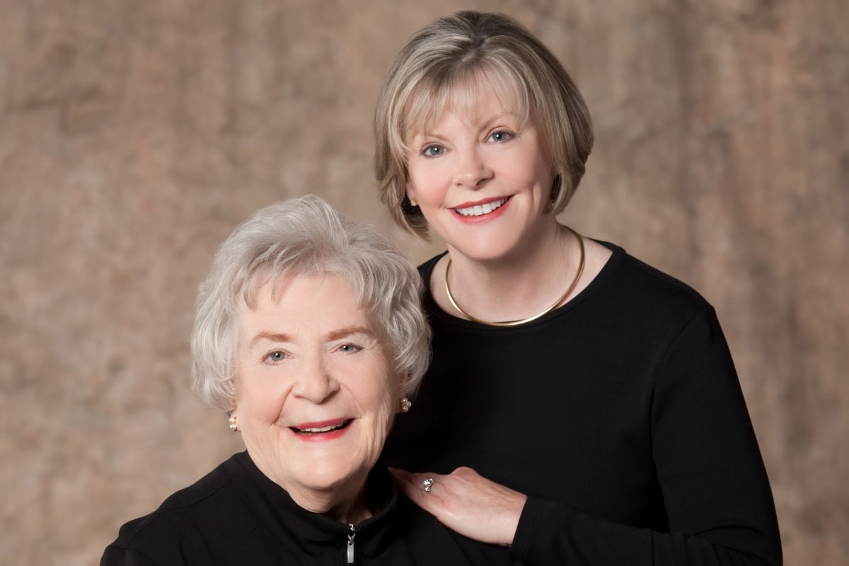 Two smiling women showing natural results from custom dentures and partials at the center for cosmetic and restorative dentistry in chesapeake, va.