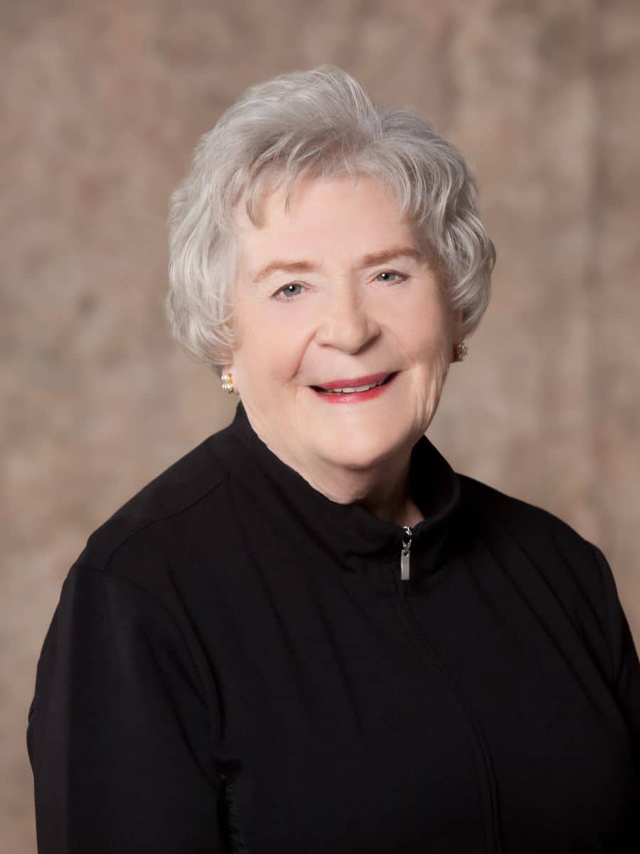 Elderly woman smiling confidently during a periodontal therapy visit in chesapeake va.