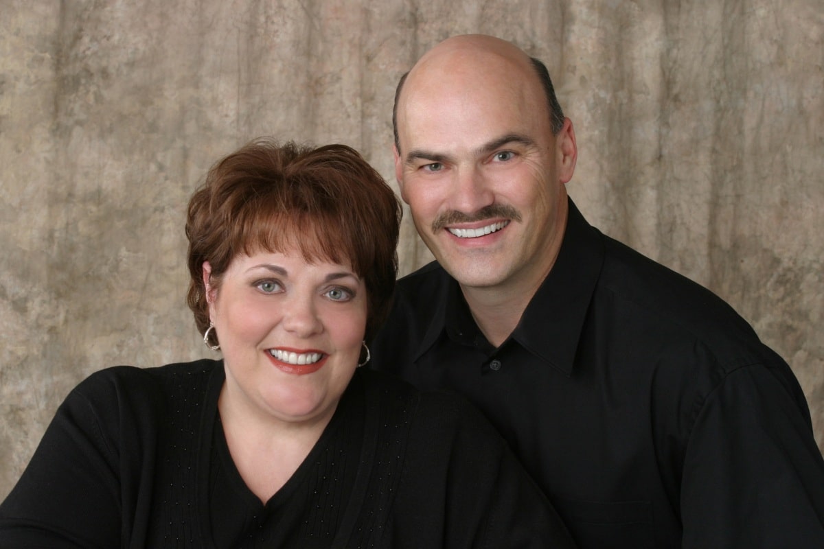 Smiling couple showing natural-looking results after cosmetic and restorative dental treatments in chesapeake, va.
