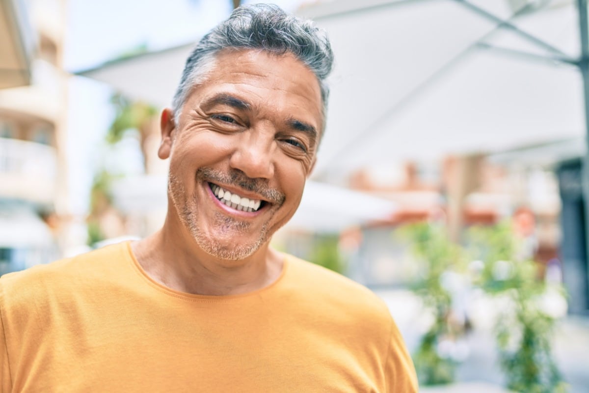 Smiling man outdoors representing a confident, stress-free first visit experience at The Center for Cosmetic and Restorative Dentistry in Chesapeake, VA.