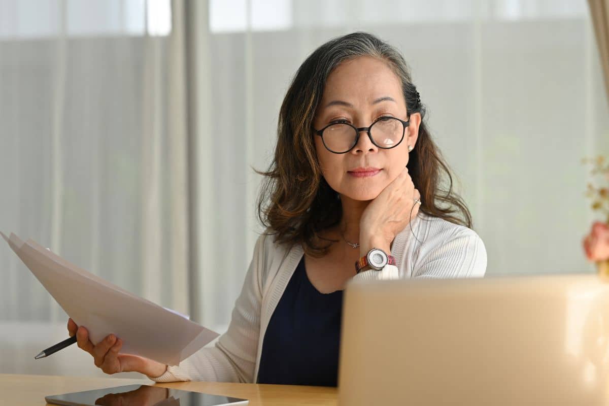 Older woman looking at a computer for post-operative dental information at the center for cosmetic and restorative dentistry in chesapeake, va