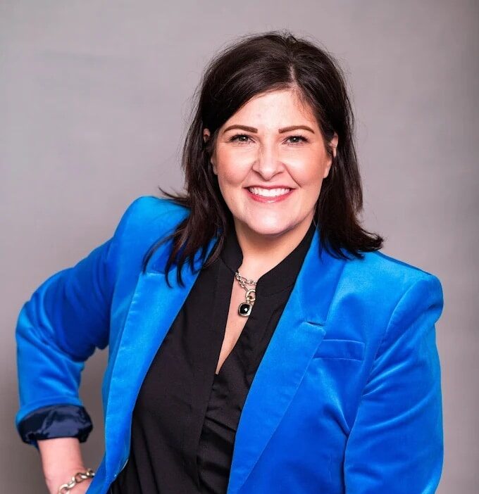 Tmj-airway-treatment-chesapeake-va Smiling professional woman wearing a blue blazer, representing tmj and airway treatment expert in chesapeake, va.